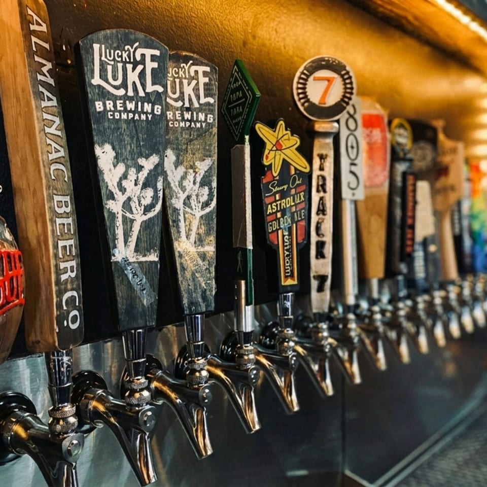 A row of beer taps with various branded handles, including "Rogue" and "Lucky Luke".